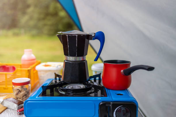 Coffee maker on a gas cooker outside a tent Coffee maker on a gas cooker outside a tent camping stove photos stock pictures, royalty-free photos & images