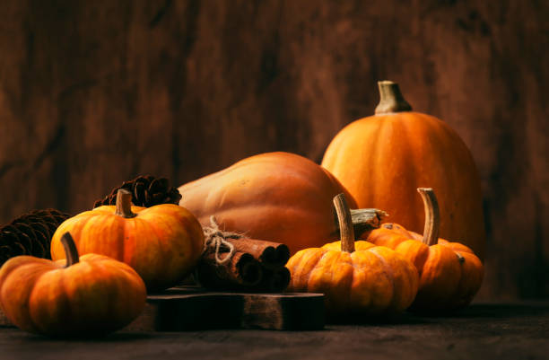 istock Thanksgiving Pumpkins Cinnamon And Pine Cones On Rustic Wooden Table Background - Autumn Thanksgiving Or Harvest Festival Concept 1270260193