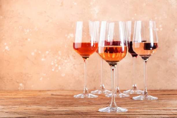 istock Rose wine glasses assortment on wine tasting. Degustation different varieties, colors and shades of pink wine concept. Beige background 1270260843