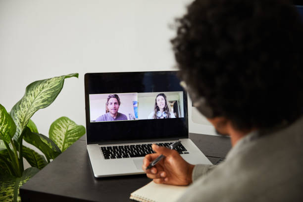 istock Man on a video call with colleagues while working remotely from home 1270261761
