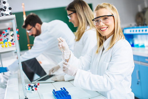 Young Scientists examining samples of DNA in laboratory