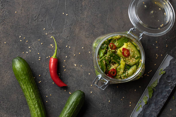 smashed cucumber salad with fresh coriander leaves and chilli. dish of national chinese cuisine. asian cucumber salad - sesame cooking oil premium organic imagens e fotografias de stock