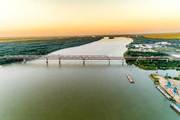 Aerial view of steel truss bridge over the Danube River - (Bulgarian: Дунав мост, Русе, България) Aerial view of a steel truss bridge over the Danube River - (Bulgarian: Дунав мост, Русе, България).  River connecting Bulgarian and Romanian banks between Ruse and Giurgiu cities.  The picture is taken with DJI Phantom 4 Pro drone / quadcopter danube valley stock pictures, royalty-free photos & images