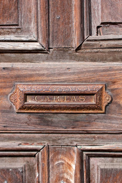 istock Old colonial mailbox on the aged wooden door with writing Letters on it, vertical composition, Antigua, Guatemala 1270264578