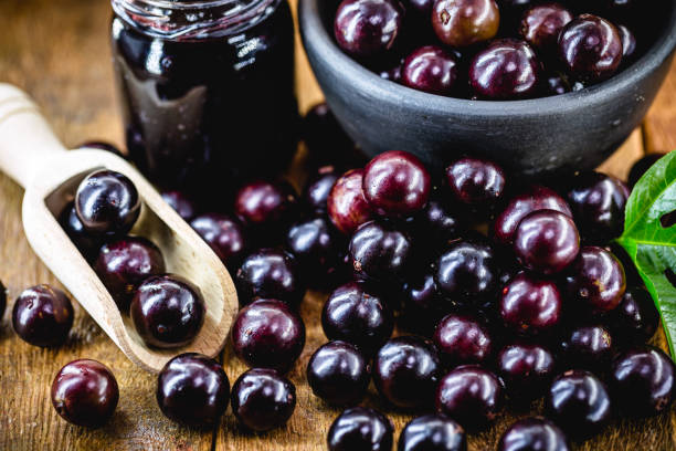 istock Brazilian grape jam, on a rustic wooden table. Jabuticaba, exotic fruit from Brazil, used in cooking as a sweet. 1270265413