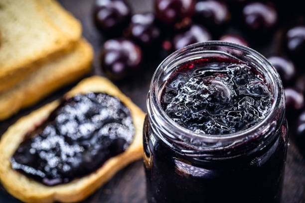 istock Brazilian grape jam, on a rustic wooden table. Jabuticaba, exotic fruit from Brazil, used in cooking as a sweet. 1270265451