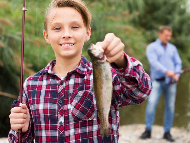 istock Portrait of smiling boy having fish in hands 1270266259