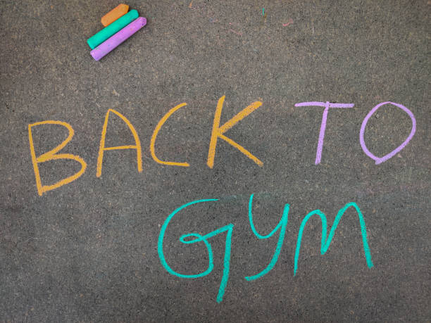 istock The inscription text on the grey board, BACK TO GYM. Using color chalk pieces. Post corona concept 1270266520
