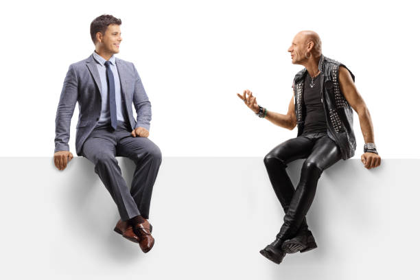 istock Punk talking to a professional man seated on a blank panel 1270266599