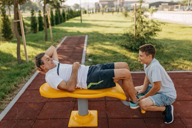 Senior man and grandson working out together