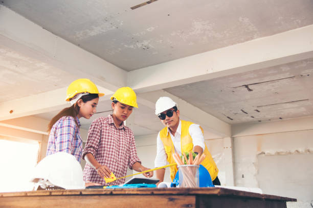 Team engineering work meeting together. Team conference in construction site. Team engineering work meeting together. Team conference in construction site. general construction specialist stock pictures, royalty-free photos & images