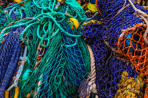 old used fishing nets floats ropes in a pile