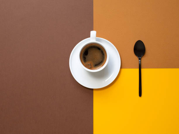 Cup of coffee on a brown background with copy space.