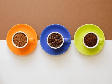 Different types of coffee and coffee beans in small mugs. Coffee concept.