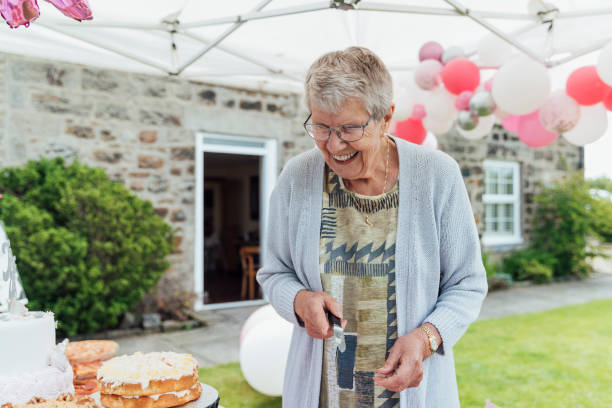 istock Senior Woman Cutting A Cake 1270271338