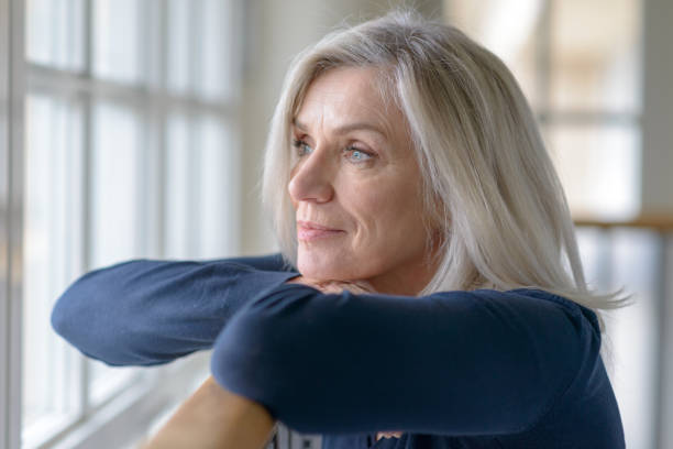 istock Attractive blond woman standing daydreaming 1270272345