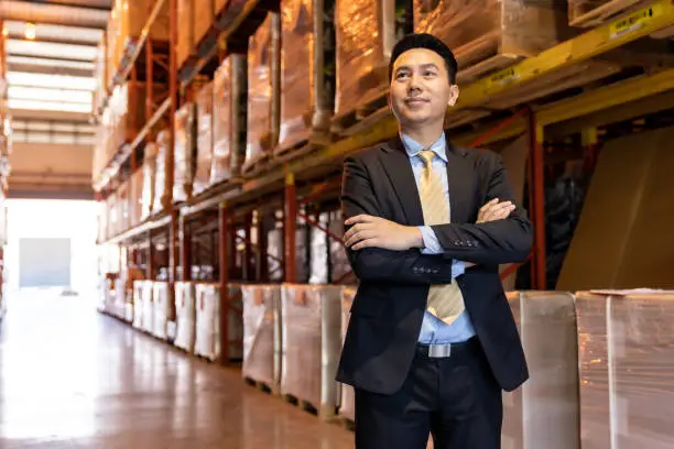 Photo of Asian businessman owner portrait in distribution warehouse