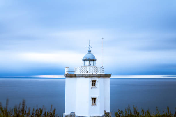 istock Lighthouse at sunset with clouds in the sky 1270275661
