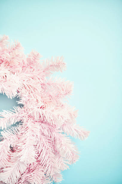Pink Tinsel Christmas Wreath on Vibrant Blue Background