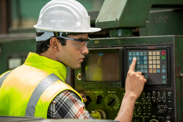 istock Engineers operating a cnc machine in factory 1270276345