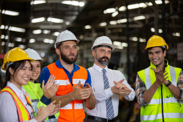 istock Group of Engineer manager and Factory Workers Team standing against production line. 1270276367