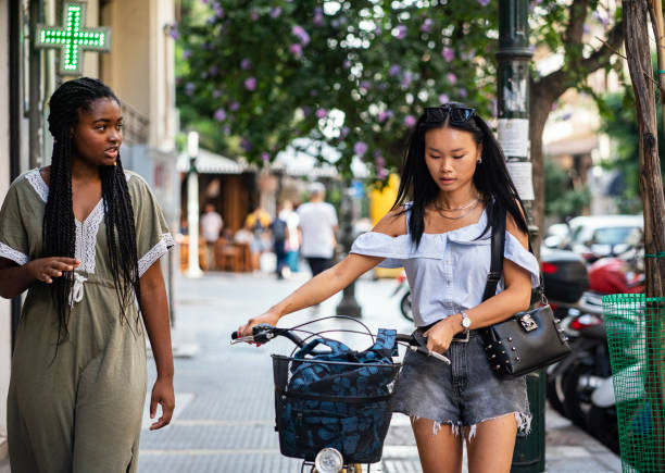 istock Two friends walking through city with bicycle 1270280421