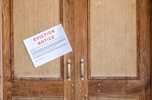 Eviction notice pasted on the entrance door of the house.