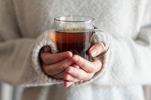 Woman holding a cup of hot tea