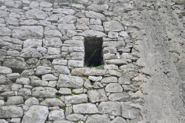 istock Stone ancient wall with window in the middle, abandoned 1270282918