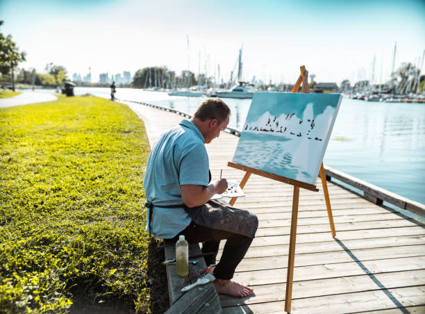 istock Man painting at the Lake shore 1270284927