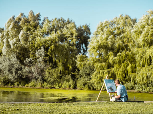 istock Man painting at the Lake shore 1270285298
