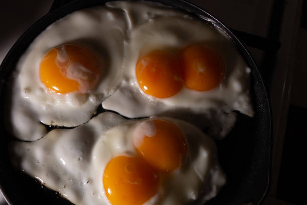 istock Scrambled eggs made from three eggs, two of which with two yolks in a skillet. 1270289606