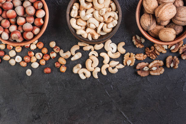istock Walnut, hazelnut and cashews in pottery, view from above 1270290132