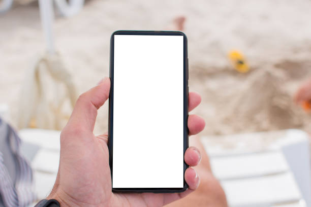 istock smartphone in hand on the beach 1270290210