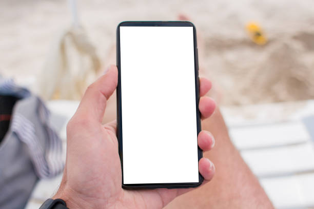 istock smartphone in hand on the beach 1270291564