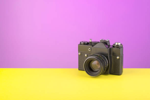 istock old film camera on purple background 1270292252