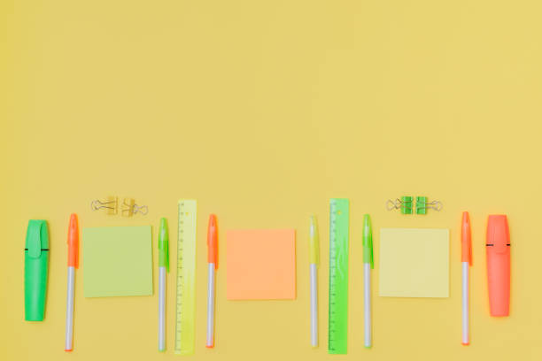istock Flat lay border with school supplies on a yellow background 1270292883