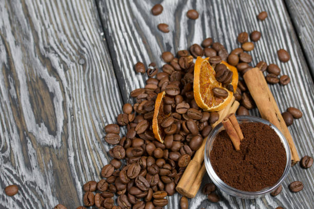 istock Coffee beans and spices. Ground coffee container. On a surface of brushed pine boards painted black and white. 1270293764