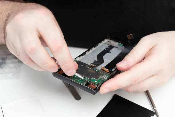 istock Replacing defective modules in a mobile phone. The wizard collects a smartphone from the details 1270294099