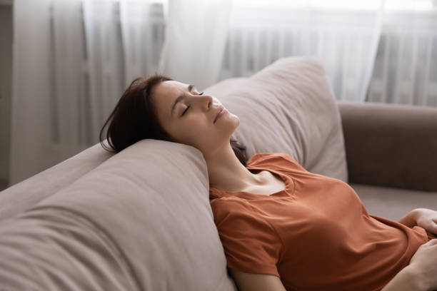 istock Calm girl relax on couch at home taking nap 1270295089