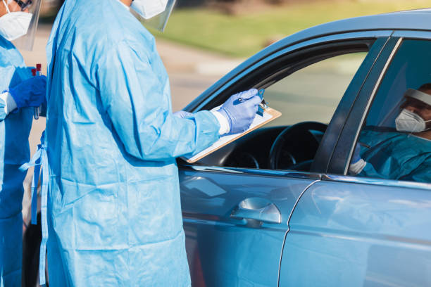 istock Unrecognizable nurse gathers information from patient at COVID test site 1270296100