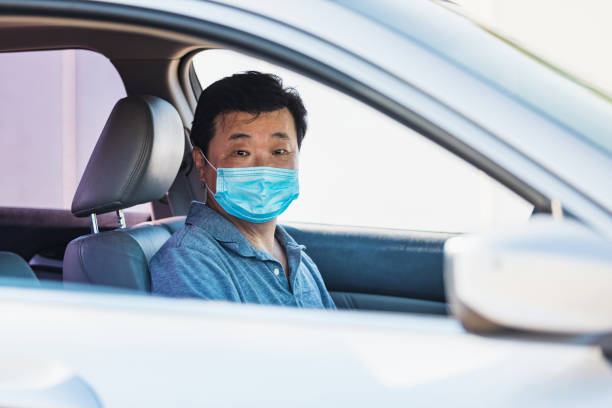 istock Anxious senior man waits in COVID-19 testing line 1270296162