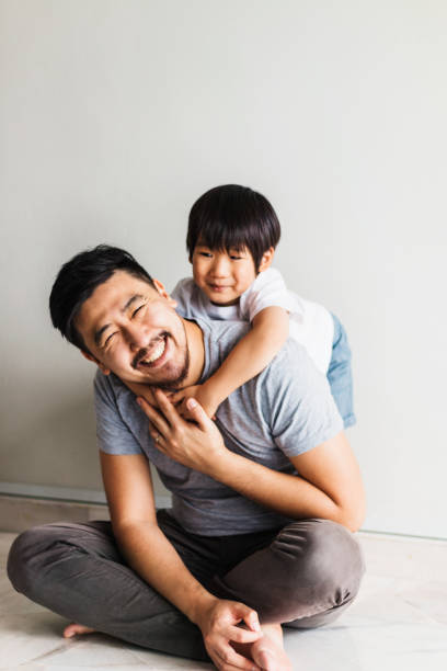 istock Dad smiles as son climbs on his back 1270296236