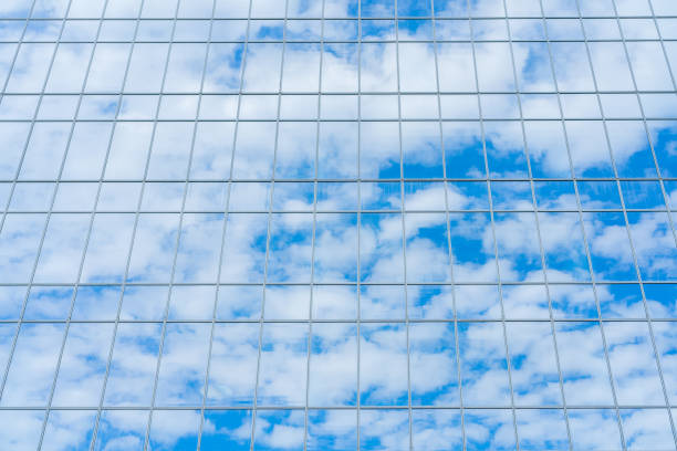 istock Reflection of the sky and clouds in the glass wall. 1270296659