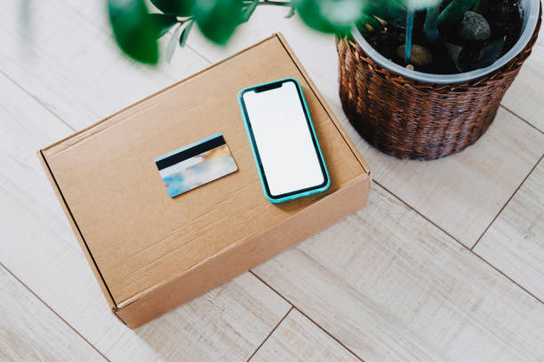 istock Box, a smartphone and a plastic credit card to pay for the goods received 1270297841