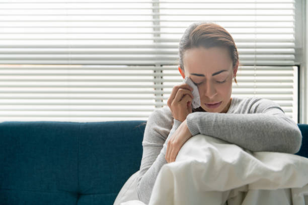 istock Depressed woman crying at home 1270299838