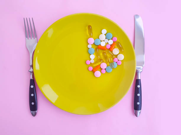 istock plate of pills vitamins on a colored background 1270300955