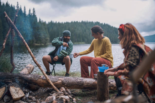 istock Young Cheerful People Are Having Fun And Drinking Tea Next To The Camp Fire 1270303814
