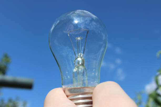 istock Antique incandescent lamp in a man's hand. 1270304975