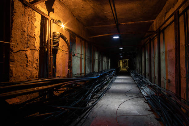 istock Underground cable tunnel with a cable coupling in the foreground. Underground tunnel with optical cables for internet, television and telephone. 1270304981
